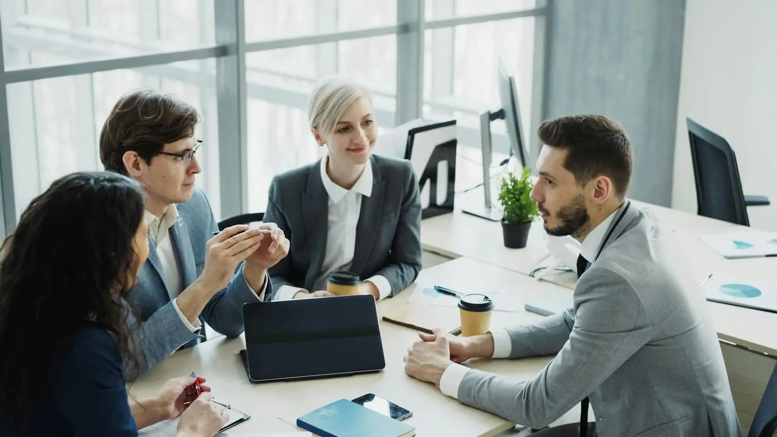 A consultant meeting with clients in a bright office