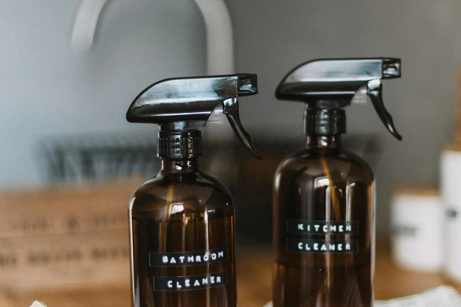 Household cleaning products in amber spray bottles