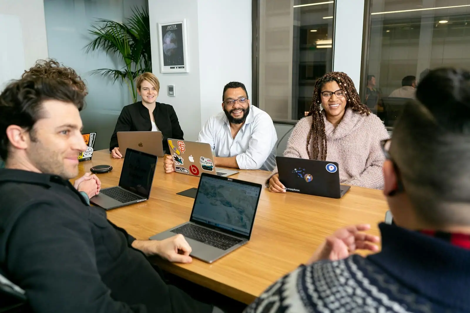 Colleagues smiling around a meeting table