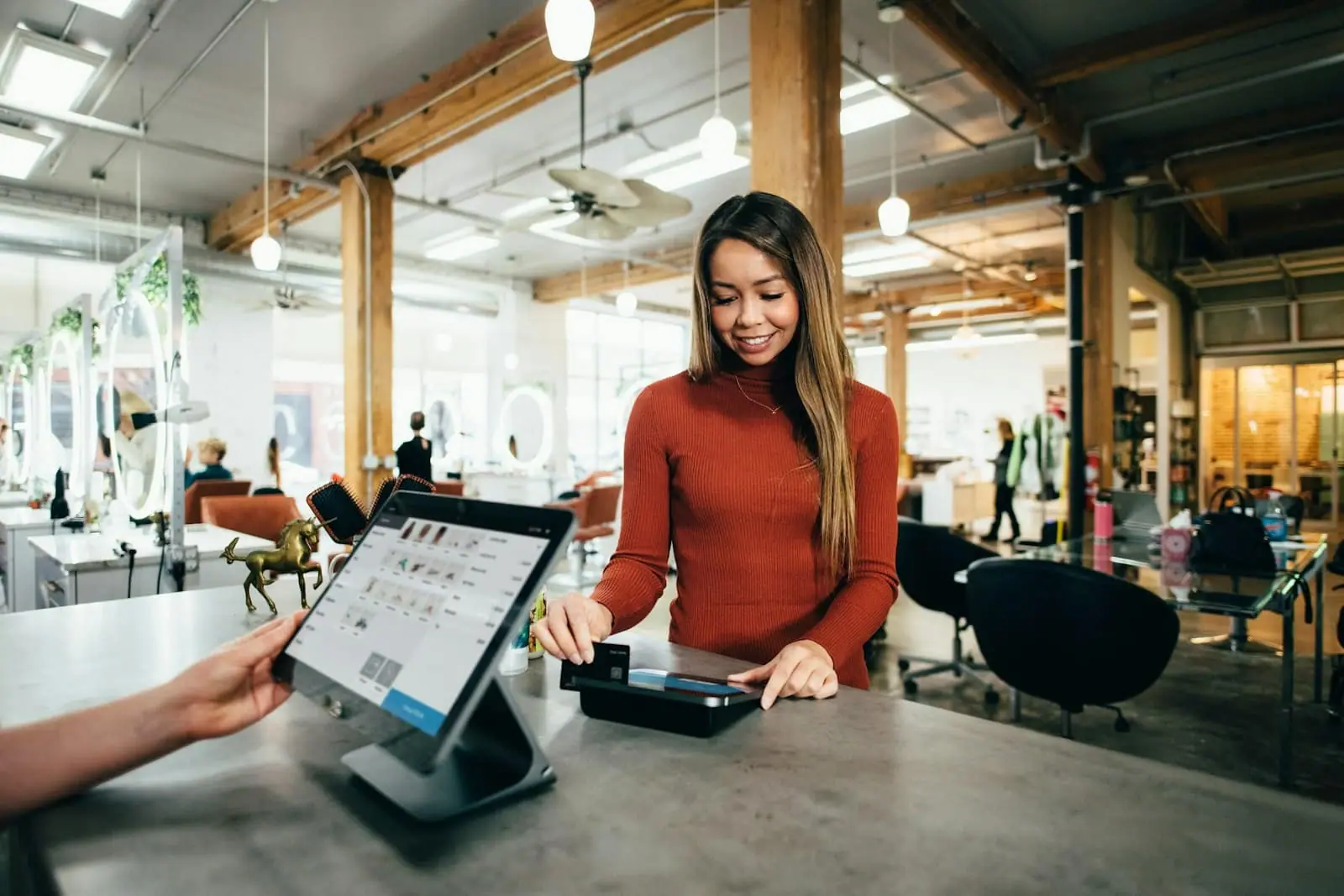 A customer paying by card at a point-of-sale tablet
